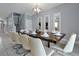 Elegant dining room with a large table, eight chairs, and a modern chandelier at 1680 Moon Valley Dr, Davenport, FL 33896