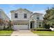Two-story home with stone accents and a three-car garage at 1680 Moon Valley Dr, Davenport, FL 33896