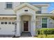 Elegant front door entry with stone columns and an arched entryway at 1680 Moon Valley Dr, Davenport, FL 33896
