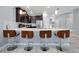 Modern kitchen with dark cabinets, white countertops and bar stools at 1680 Moon Valley Dr, Davenport, FL 33896