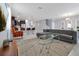 Open concept living area with gray sectional and kitchen view at 1680 Moon Valley Dr, Davenport, FL 33896