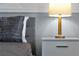 Grey bedroom nightstand with lamp and bedding at 1680 Moon Valley Dr, Davenport, FL 33896