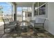Covered patio features comfortable wicker furniture and a glass-top coffee table at 1680 Moon Valley Dr, Davenport, FL 33896