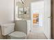 Simple bathroom with white vanity and view into kitchen at 2711 Emerald Lake Ct, Kissimmee, FL 34744