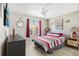 Cozy bedroom with red and gray bedding and ceiling fan at 2711 Emerald Lake Ct, Kissimmee, FL 34744