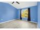 Bright bedroom with vaulted ceilings, wood-look floors, and a large window at 2711 Emerald Lake Ct, Kissimmee, FL 34744