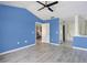 Spacious bedroom with wood-look floors and access to bathroom at 2711 Emerald Lake Ct, Kissimmee, FL 34744