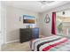 Spacious bedroom with dresser and a comfortable bed at 2711 Emerald Lake Ct, Kissimmee, FL 34744