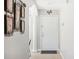 Bright condo entryway with white door and decorative wall art at 2711 Emerald Lake Ct, Kissimmee, FL 34744