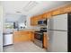 Modern kitchen with stainless steel appliances and wood cabinets at 2711 Emerald Lake Ct, Kissimmee, FL 34744