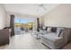 Living room with sectional sofa and balcony access overlooking water at 2711 Emerald Lake Ct, Kissimmee, FL 34744