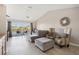 Living room with sectional sofa, water view, and access to balcony at 2711 Emerald Lake Ct, Kissimmee, FL 34744