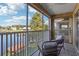 Relaxing screened balcony overlooking a lake with wicker furniture at 2711 Emerald Lake Ct, Kissimmee, FL 34744
