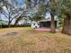 Large backyard with firepit and screened porch at 3700 Timber Trl, Orlando, FL 32808