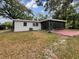Backyard view showing a screened patio and a large grassy area at 3700 Timber Trl, Orlando, FL 32808