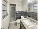 Updated bathroom with a granite vanity and dark gray tile at 3700 Timber Trl, Orlando, FL 32808