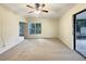 Spacious living room with carpet, large window, and sliding glass doors at 3700 Timber Trl, Orlando, FL 32808