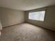 Spacious bedroom with neutral carpeting and large window at 4215 S Semoran Blvd # 10, Orlando, FL 32822