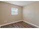 Small bedroom with wood-look floors and a window at 5235 Botany Ct, Orlando, FL 32811