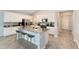 Modern kitchen with island, white cabinets, and grey countertops at 729 Hitch Loop, St Cloud, FL 34772
