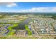 Aerial view showing community layout, lake, and surrounding landscape at 8033 Surf St, Kissimmee, FL 34747