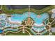 Aerial view of large resort pool with surrounding lounge chairs and umbrellas at 8033 Surf St, Kissimmee, FL 34747