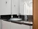 Bathroom with single vanity, granite countertop, and mirror at 836 Desert Mountain Ct, Reunion, FL 34747