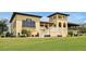 Two-story clubhouse with balconies and manicured lawn at 836 Desert Mountain Ct, Reunion, FL 34747