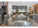 Modern dining area with glass table and gray chairs, open to kitchen at 836 Desert Mountain Ct, Reunion, FL 34747