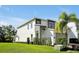 Modern home with gray siding, stone accents, and lush landscaping at 836 Desert Mountain Ct, Reunion, FL 34747