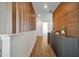 Modern hallway with wood wall accents and built-in beverage center at 836 Desert Mountain Ct, Reunion, FL 34747