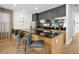 Modern kitchen with wood cabinets, black countertops, and stainless steel appliances at 836 Desert Mountain Ct, Reunion, FL 34747