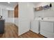 Bright laundry room with washer, dryer, and ample shelving at 836 Desert Mountain Ct, Reunion, FL 34747
