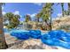 Blue tubes sit by the lazy river, ready for use at 836 Desert Mountain Ct, Reunion, FL 34747