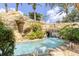 Relaxing lazy river with a cave and waterfall feature at 836 Desert Mountain Ct, Reunion, FL 34747