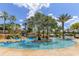 Tranquil lazy river pool with lush landscaping and waterfalls at 836 Desert Mountain Ct, Reunion, FL 34747