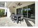 Covered patio with outdoor dining and pool access at 836 Desert Mountain Ct, Reunion, FL 34747