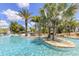 Relaxing resort-style pool with palm trees and a sandy beach area at 836 Desert Mountain Ct, Reunion, FL 34747