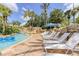 Relaxing resort-style pool with lounge chairs and lush landscaping at 836 Desert Mountain Ct, Reunion, FL 34747