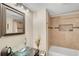 Bathroom with a glass sink, bathtub, and tiled shower at 1038 E Michigan St # 1, Orlando, FL 32806