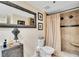Bathroom with toilet, shower, and a decorative mirror at 1038 E Michigan St # 1, Orlando, FL 32806