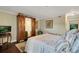 Elegant bedroom with a large bed, antique wardrobe, and hardwood floors at 1038 E Michigan St # 1, Orlando, FL 32806