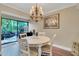 Bright dining room with white table and access to a private patio at 1038 E Michigan St # 1, Orlando, FL 32806
