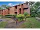 Condo building exterior showcasing landscaping and building features at 1038 E Michigan St # 1, Orlando, FL 32806