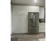 Modern kitchen with stainless steel refrigerator and white cabinets at 10722 Mottram Pt, Orlando, FL 32832