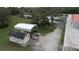 Aerial view showing home, detached garage, and other outbuildings on a large lot at 1111 Sunflower Trl, Orlando, FL 32833