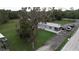 Aerial view of a mobile home with a large tree and vehicles at 1111 Sunflower Trl, Orlando, FL 32833