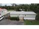 Single-wide mobile home with grey siding, steps, and landscaping at 1111 Sunflower Trl, Orlando, FL 32833