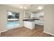 Kitchen with white cabinets, black countertops, and view of pool at 162 Pecan Dr, Ocala, FL 34472