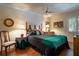Cozy bedroom with wood floors, a comfortable bed, and ample natural light at 3 Escondido Cir # 18, Altamonte Springs, FL 32701